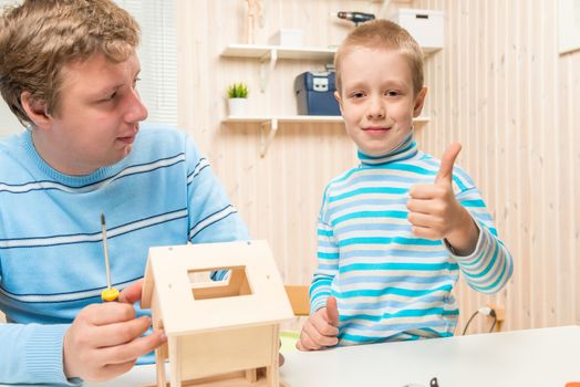 happy son happy building bird feederstogether with his father