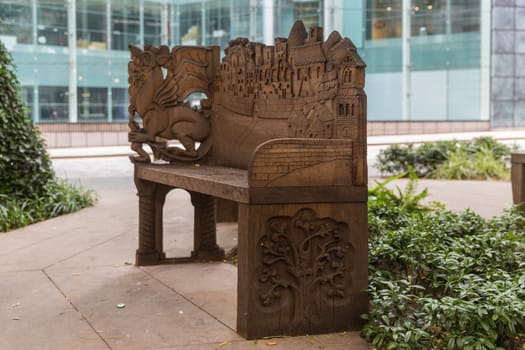 Old carved bench in the heart of the city of London - open park area