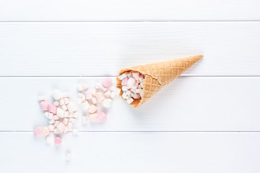 Dessert in ice cream cone on gray background on a white background