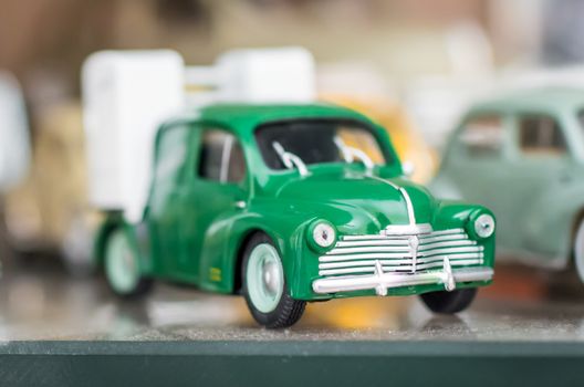 Green retro sport toy car on a glass stand