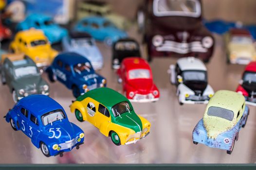 Colorful retro sport toy cars on a glass stand