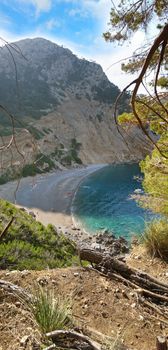 Coll Baix famous bay with beach, Majorca, Spain - view from above - vertical panorama