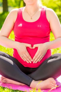 the symbolic heart symbol expectant mother, pointing to his stomach