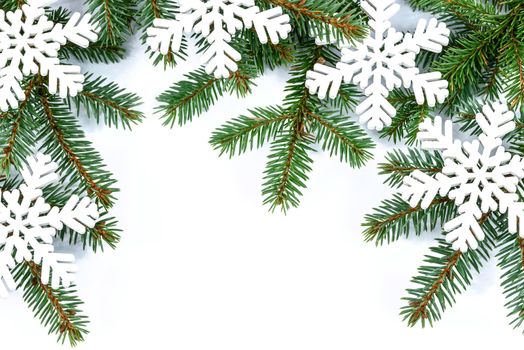 Overhead shot on branches of Siberian spruce and snowflakes isolated on a white background