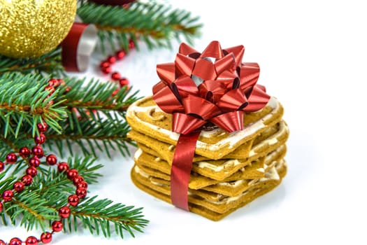 Ginger cookies decorated with a red ribbon with a Christmas decoration isolated on white background