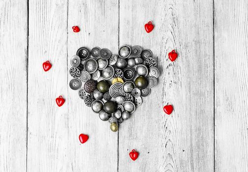 buttons are laid out in the shape of heart for Valentine's day