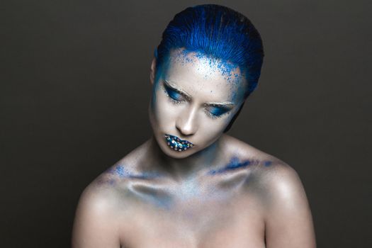 Cool Sexy Girl with Creative Festive Makeup. 
Art makeup with Blue Hair and Rhinestones on a Lips.