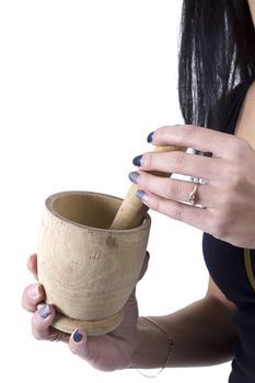 Wooden mortar in female hands on a white background