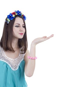 Portrait of a girl in a wreath of flowers on a white background