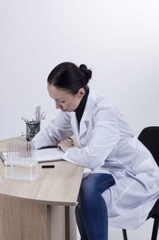 Young female doctor working at his desk