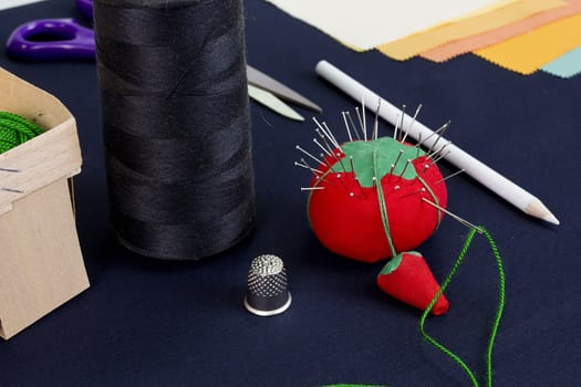 Set of accessories for sewing on a table covered with blue cloth