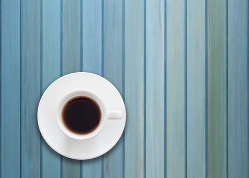 Top view of cup of fresh espresso on blue wooden background