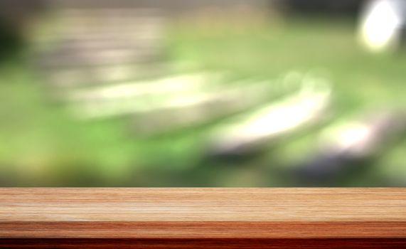 Wood table top on bokeh green background, for display your products