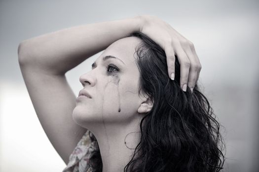 Portrait of a young crying brunette