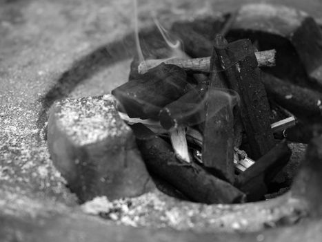 BLACK AND WHITE PHOTO OF CHARCOAL FIRE IN STOVE