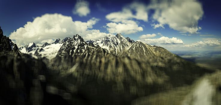 Panoramic view of the rugged snow capped mountains. Vintage effect. Vignetting effect. Bokeh. Blurred effect. High Tatras Slovakia