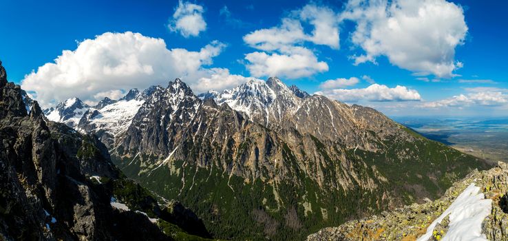 Panoramic landscape of the rugged snowy mountains. Clouds on the sky. High Tatras Slovakia