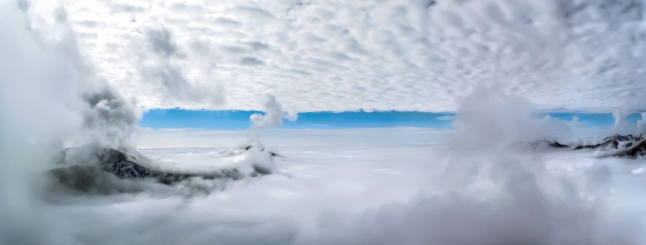 View of the lonely mountain peaks above the clouds. Autumn in the Romanian Carpathians