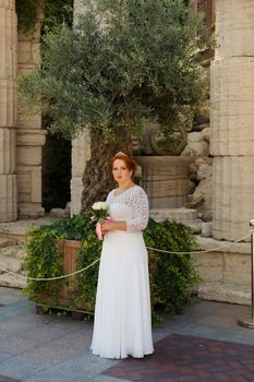 Bride big body on the wedding day for a walk