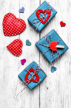 Valentines concept with wrapped gift on white wooden table