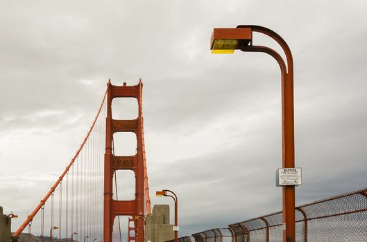 Golden Gate bridge tower and its street lamps