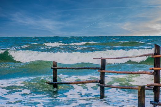 Breaking waves on an old fence in the eas sea in Germany
