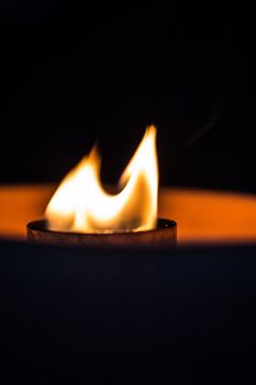 A candle flickering in the dark