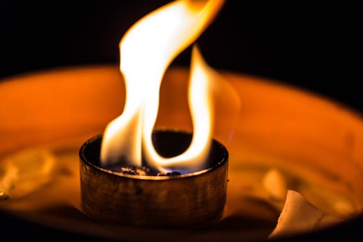 A candle flickering in the dark