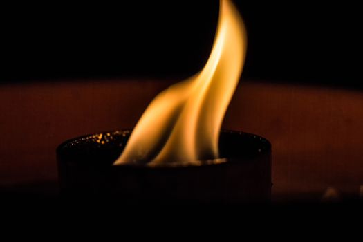 A candle flickering in the dark