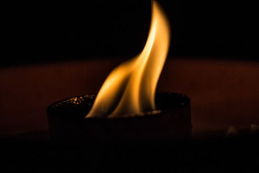 A candle flickering in the dark