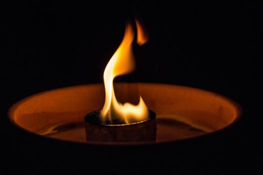 A candle flickering in the dark