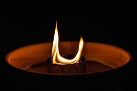 A candle flickering in the dark