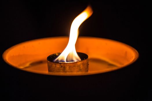 A candle flickering in the dark