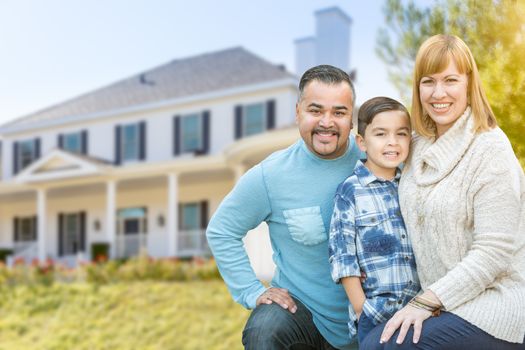 Happy Mixed Race Hispanic and Caucasian Family Portrait In Front of House.