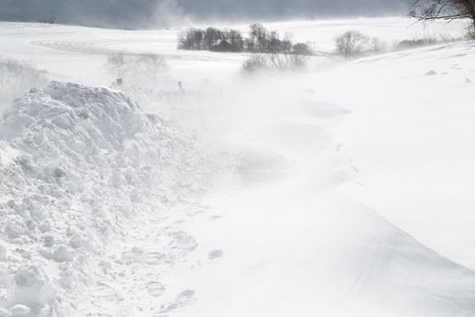 A rural road is closed with blowing drifting snow in Pennsylvania, USA.