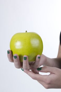 Green apple in hand on white background