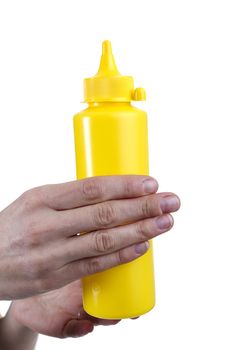 Yellow tube for sauces in female hands on a white background