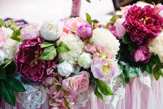 Flower decor on wedding table bride and groom in restaurant.