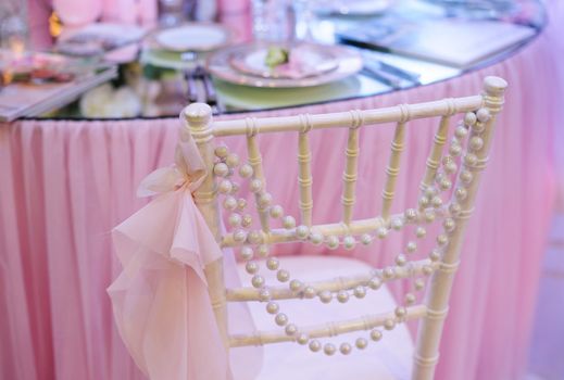 white wedding decor Chair near table in a restaurant.