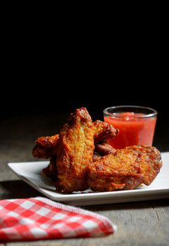 plate of chicken wings on wooden table