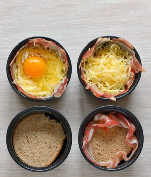fried eggs, bread and bacon in a porcelain pan