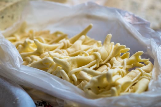 braided white cheese on the counter for sale