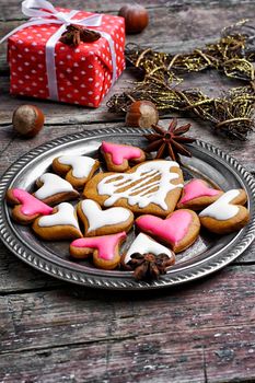 Homemade Christmas cookies in the shape of hearts on saucer