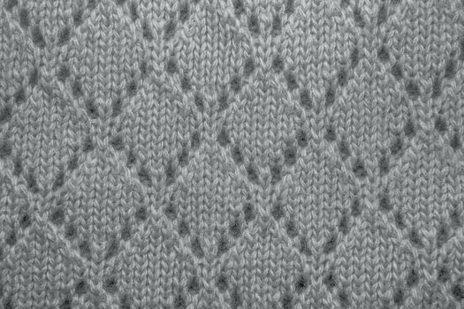 Pink wool sweater texture close up. Knitted jersey background with a relief pattern