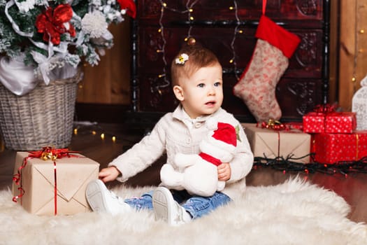 Portrait of cute little baby girl among Christmas decorations