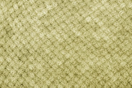 Wool sweater texture close up. Knitted jersey background with a relief pattern. Braids in machine knitting pattern