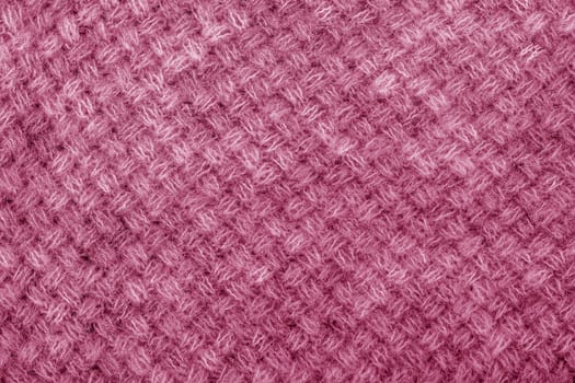 Wool sweater texture close up. Knitted jersey background with a relief pattern. Braids in machine knitting pattern