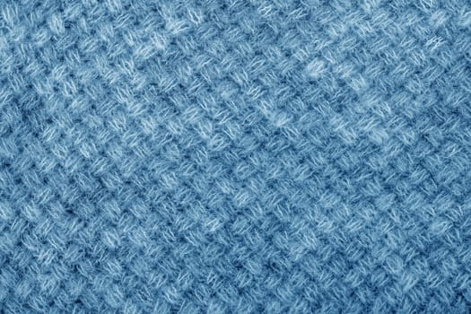 Wool sweater texture close up. Knitted jersey background with a relief pattern. Braids in machine knitting pattern
