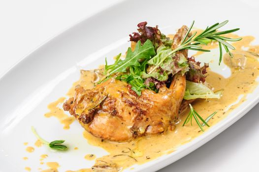 Baked and stewed rabbit legs with rosemary and lettuce