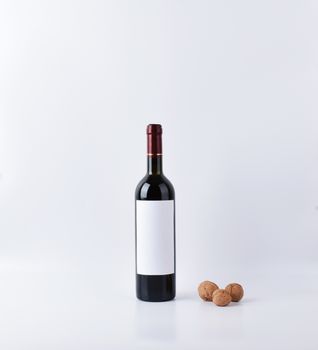 mockup wine bottle with three nuts, isolated on white background with copy space, front view.